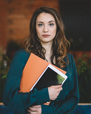 A Central Piedmont student holding folders and prints