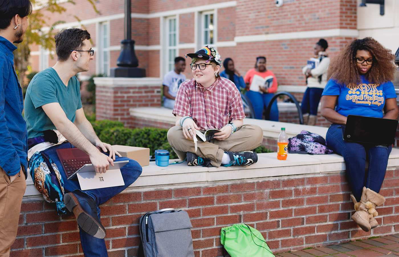 Four Central Piedmont students hanging around outside on the Central Campus