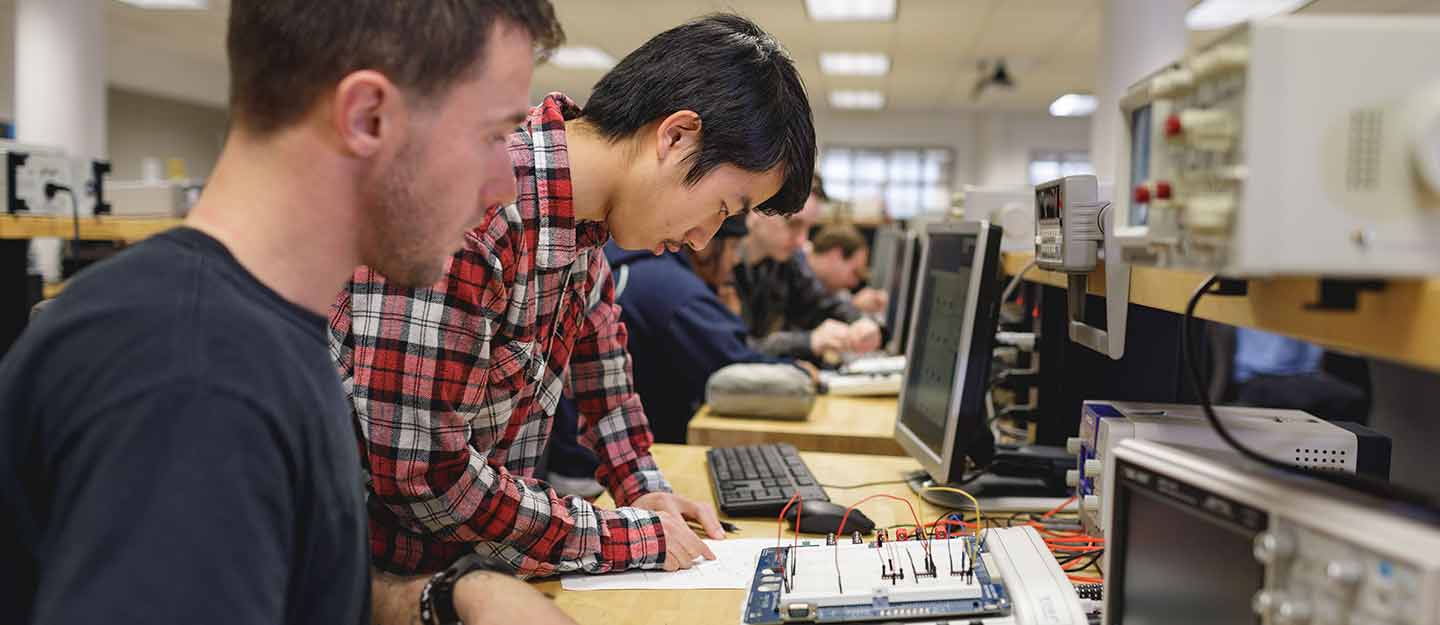 students taking notes on electronic results