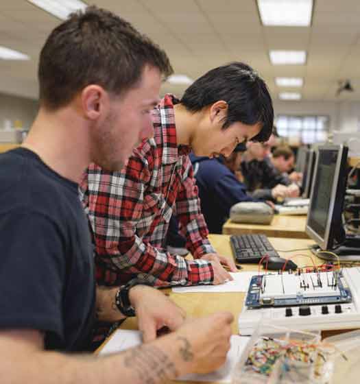 electronics engineering students taking notes