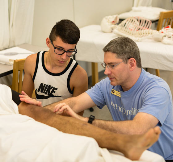 Demonstrating physical therapy on a knee