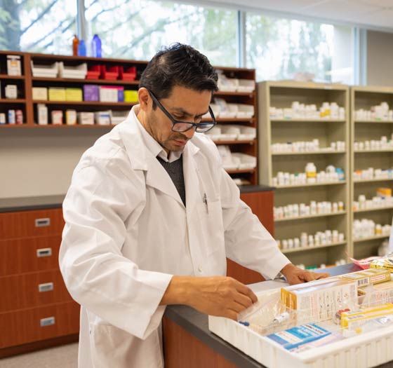 Pharmacist counting pills