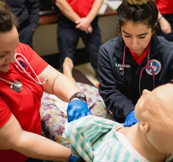 Checking vitals on a medical dummy