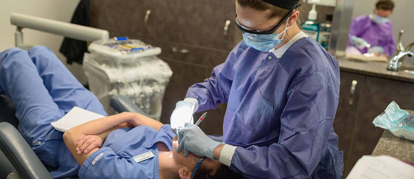 Hygenist performing a tooth cleaning