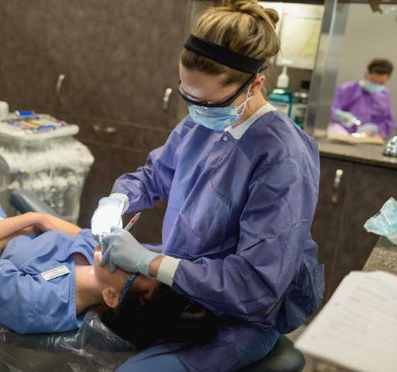 Dental hygenist cleaning teeth