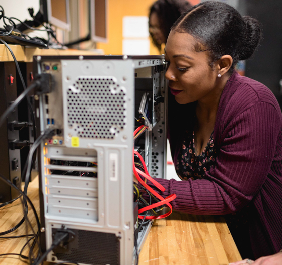 student working inside a computer
