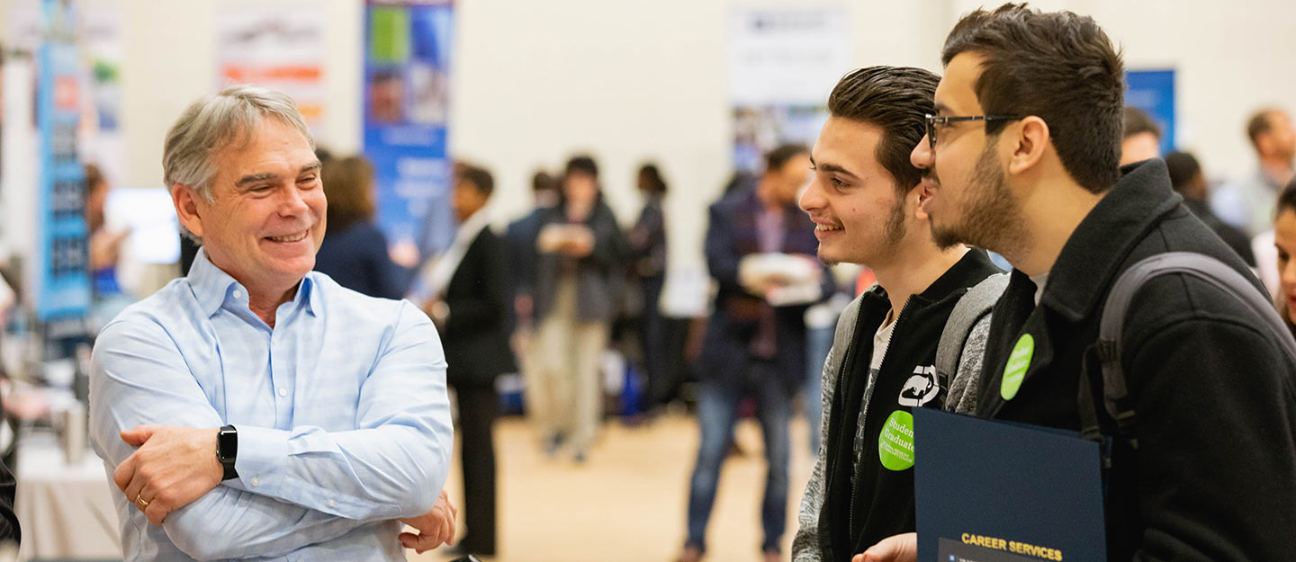 students talking to employer at Career Fair