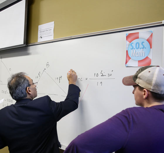 Instructor writing a proof on a whiteboard