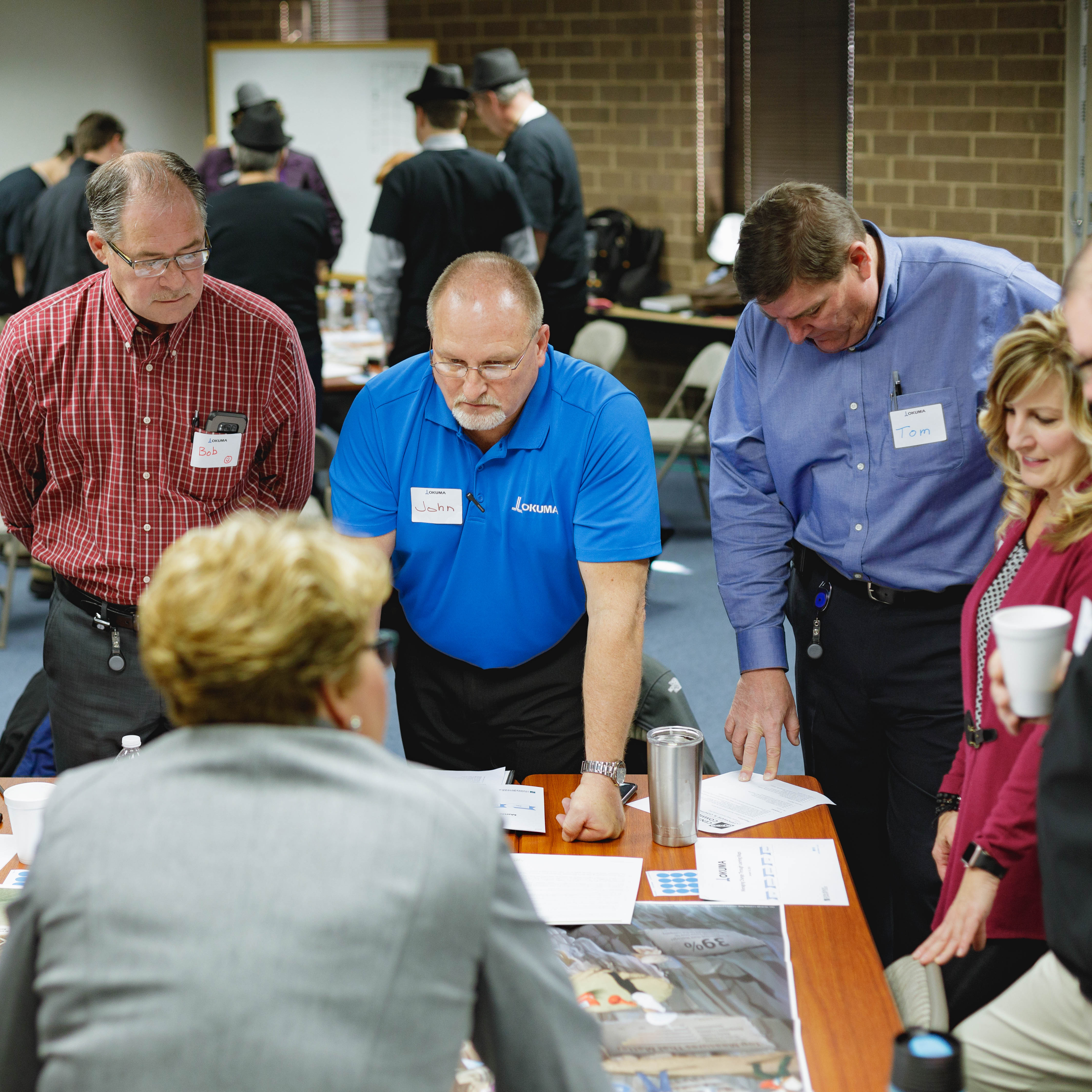 Okuma Workforce professionals in Training around table