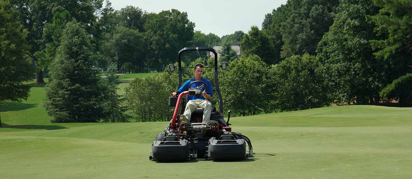 Man mowing turf