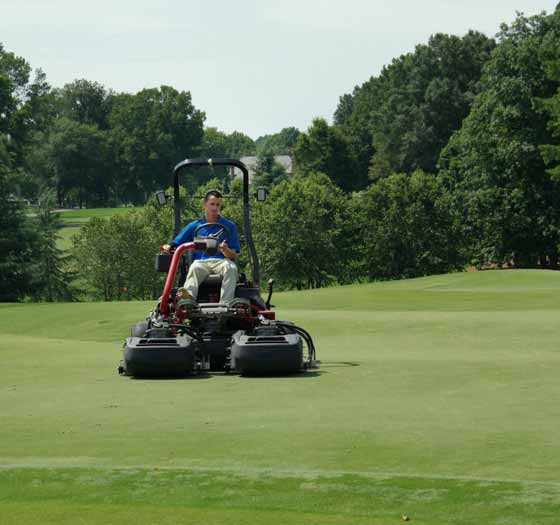 Man mowing turf grass