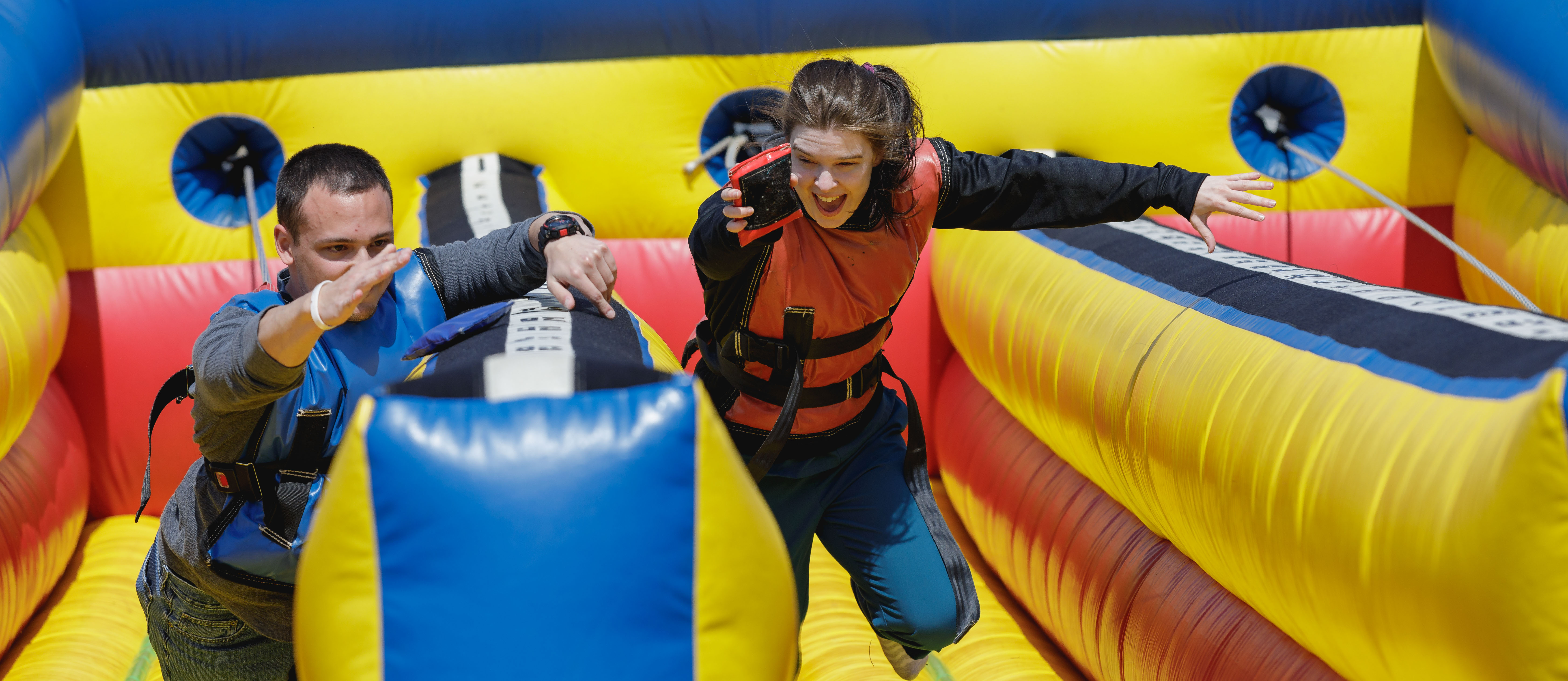 students racing on blow up track