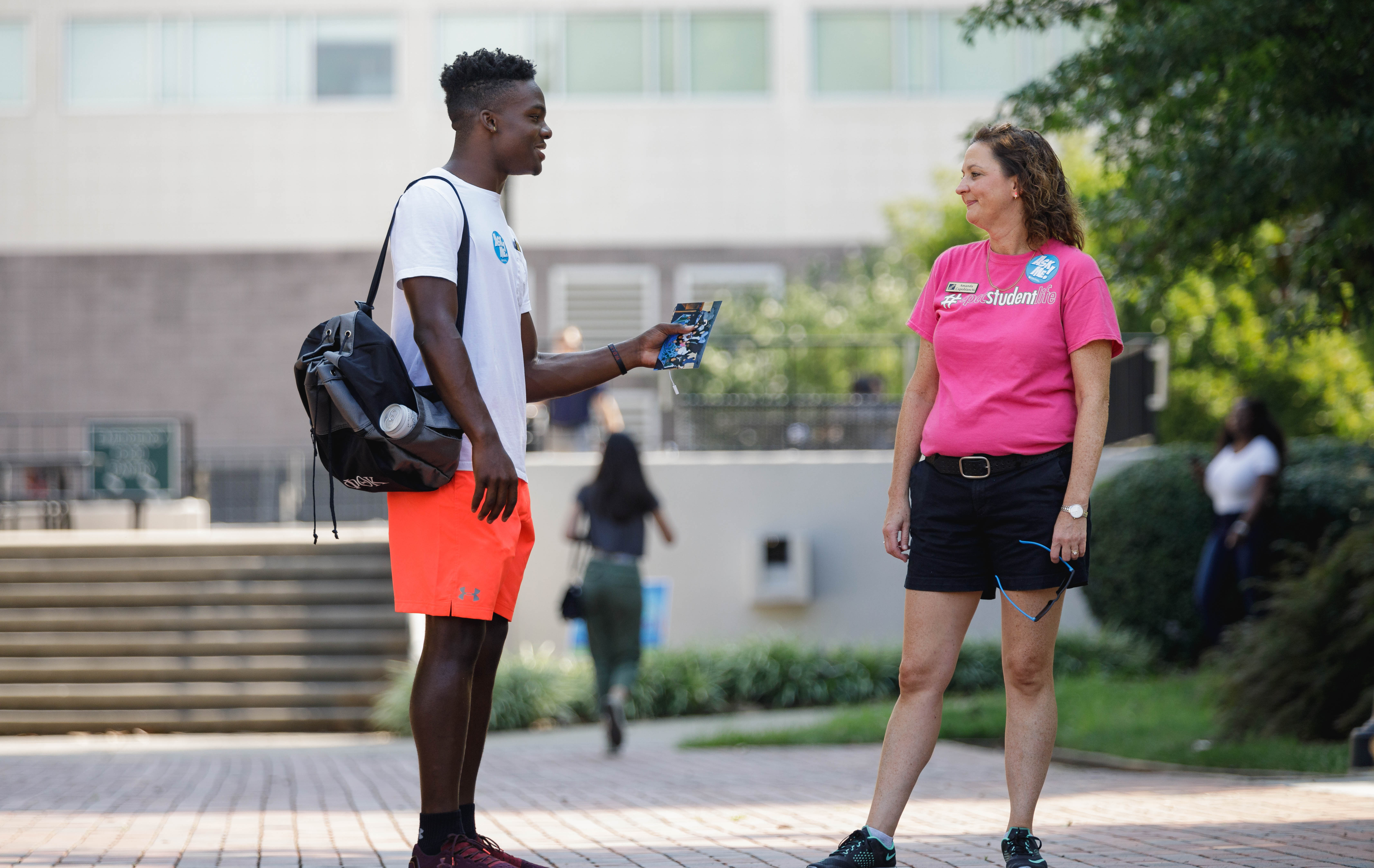 student chatting with student life staff