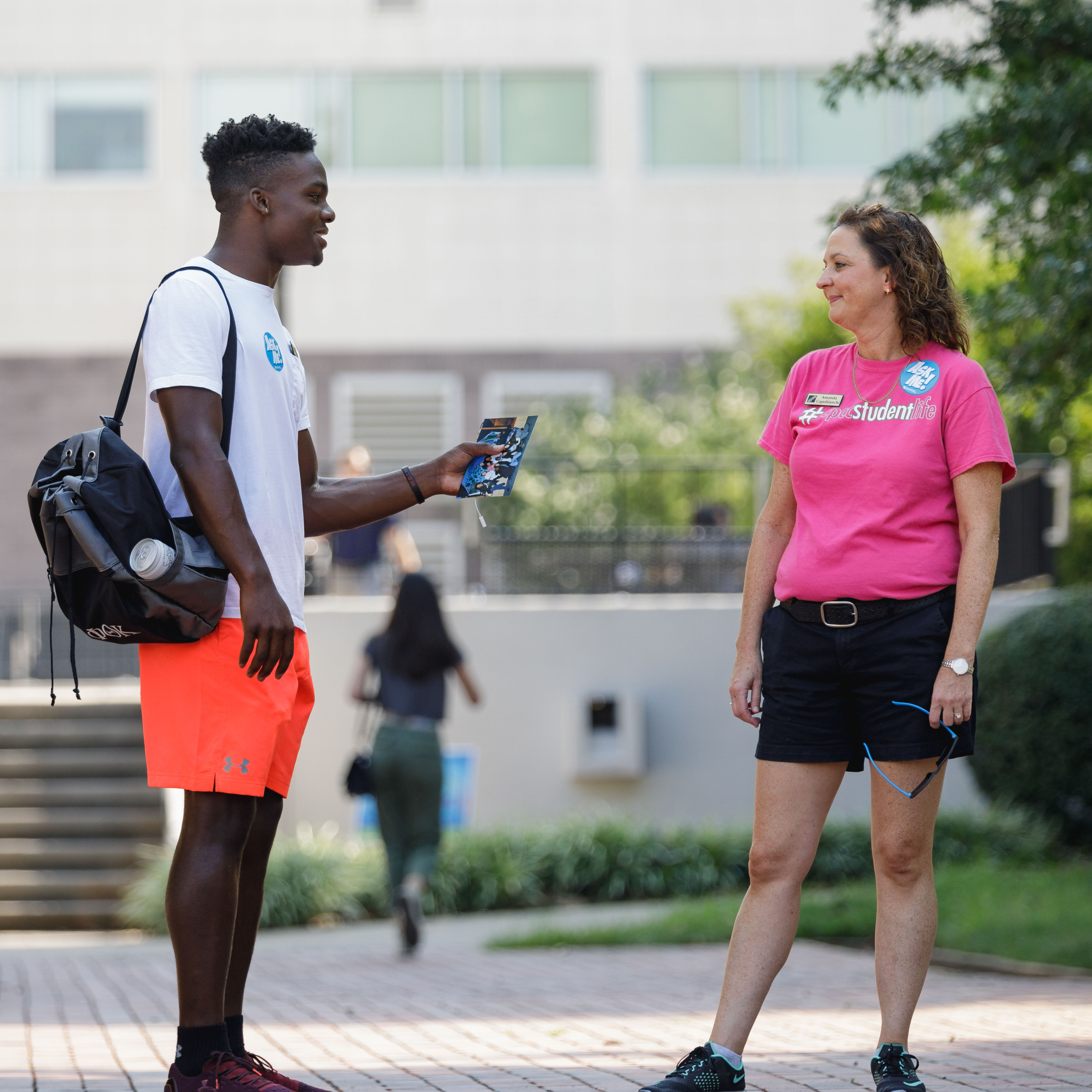 student chatting with student life staff