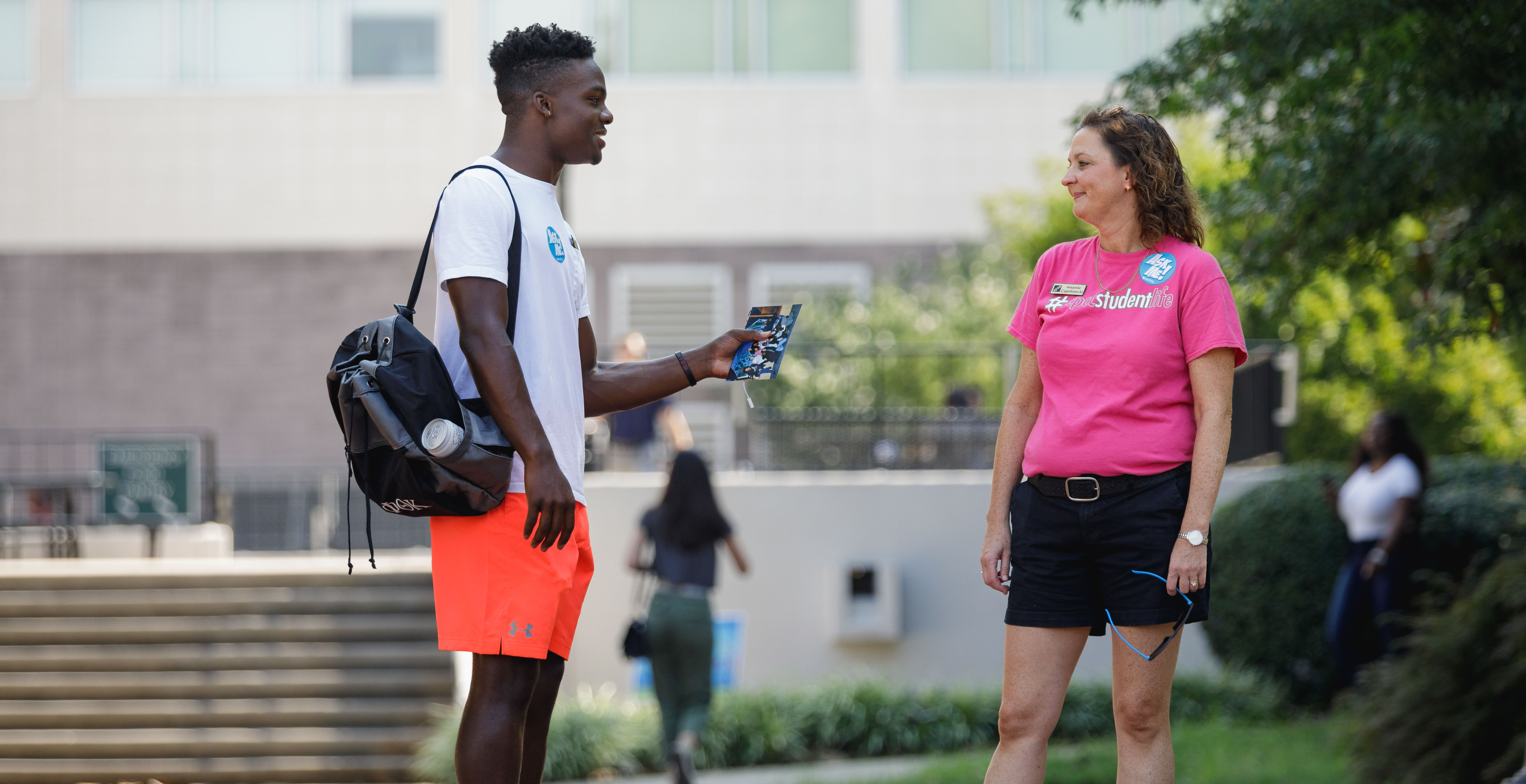 student chatting with student life staff