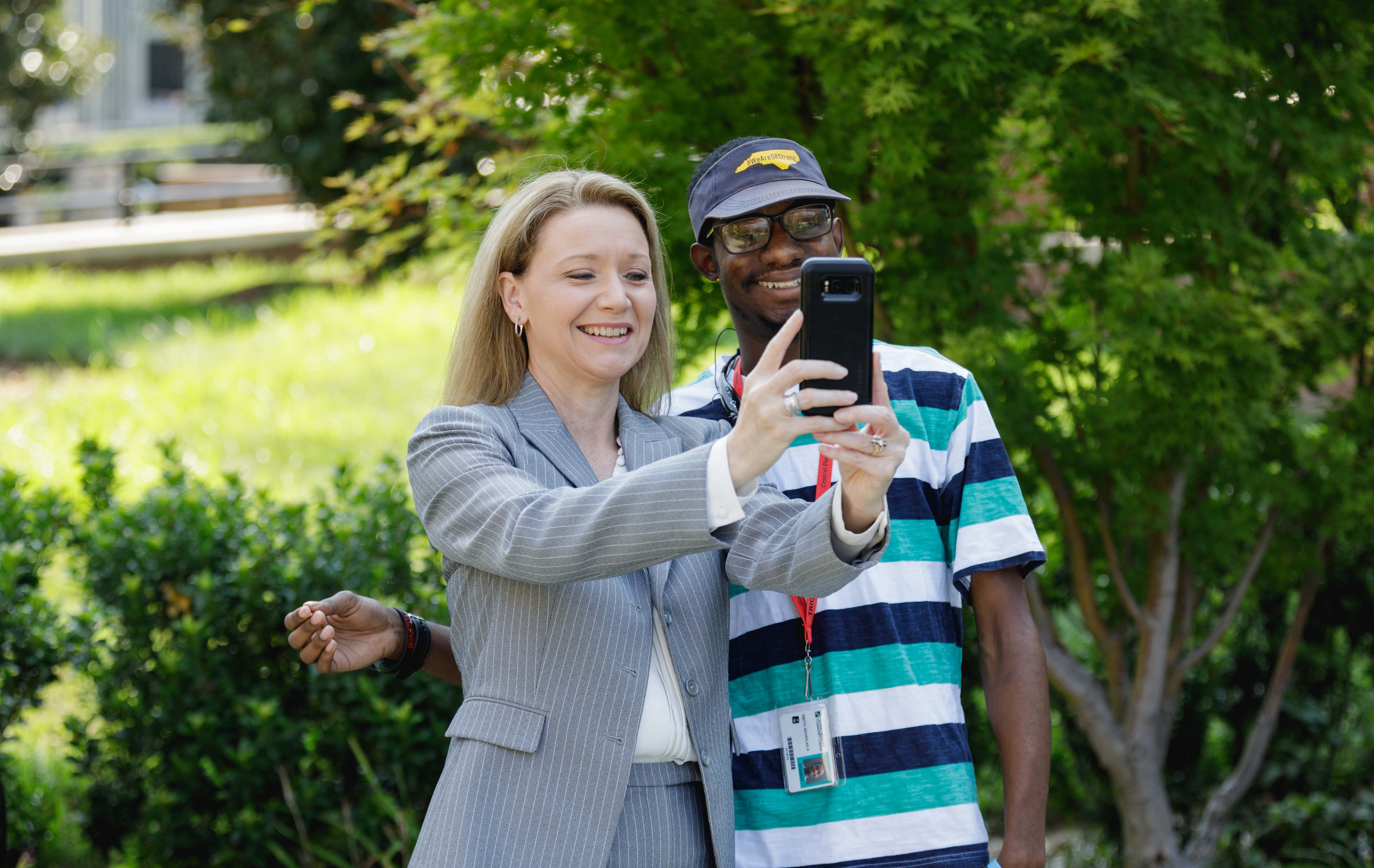 Dr. Deitemeyer taking selfie with a student