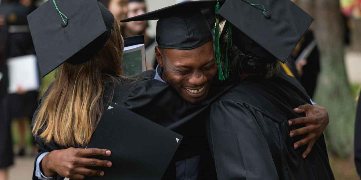 happy student hugging at graduation