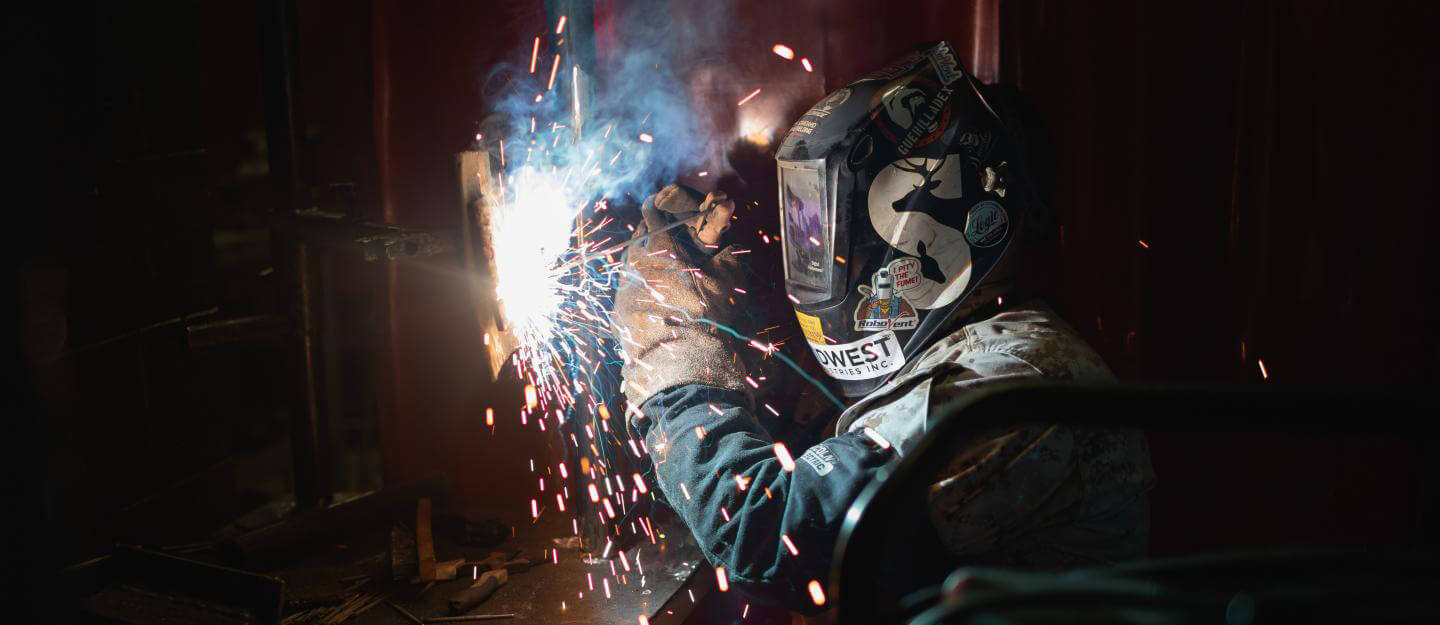 A welder wearing protective gear