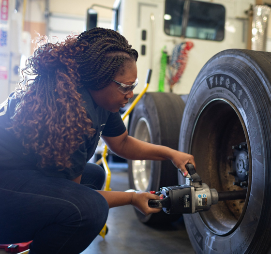 student working on large tire