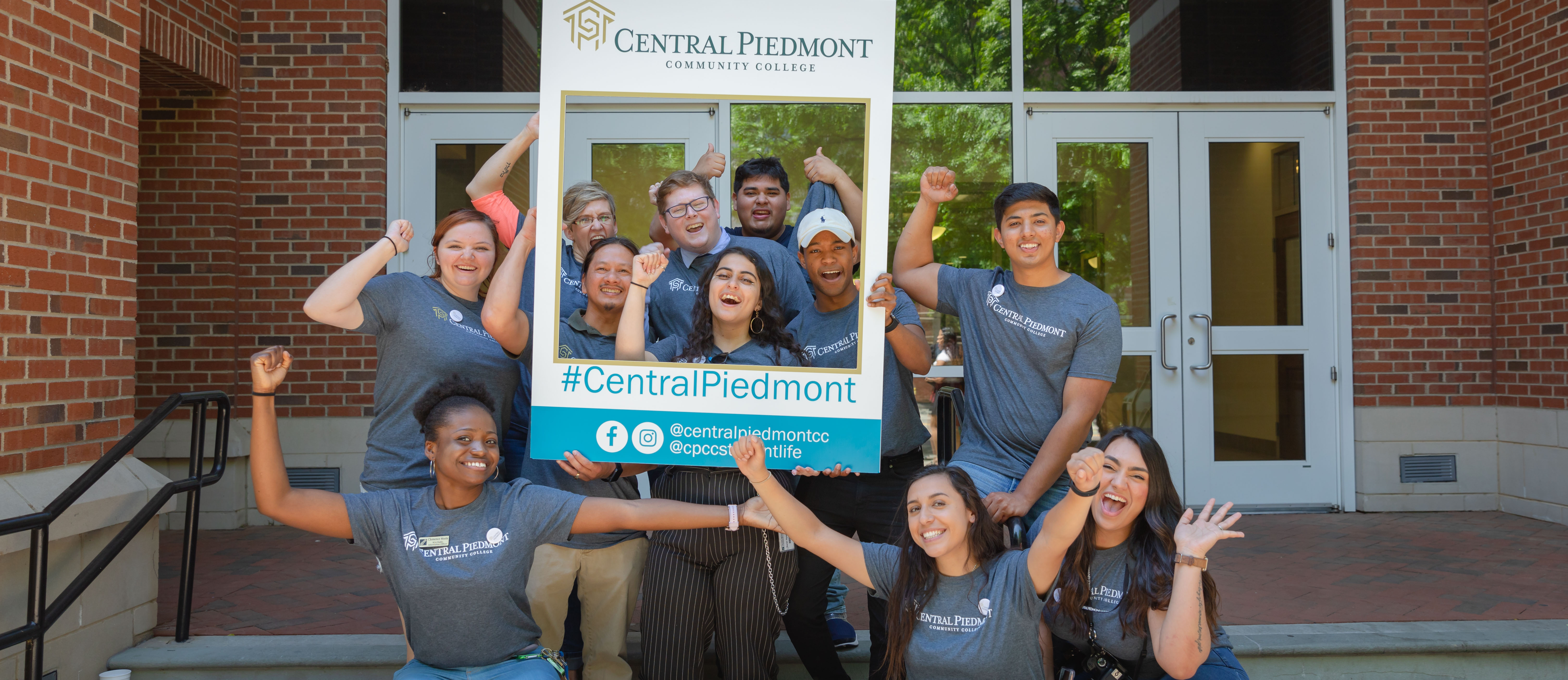 group of students with Instagram post prop at new Central Piedmont brand launch event