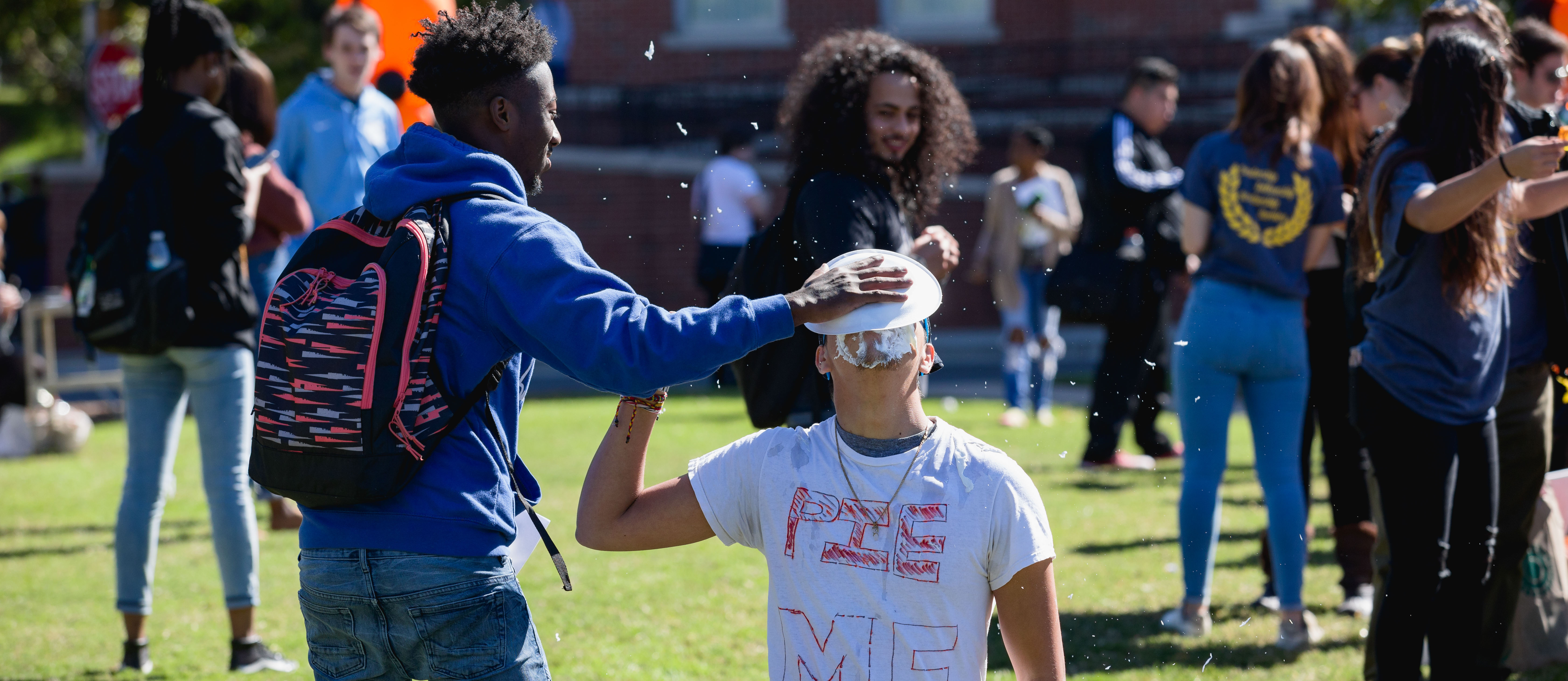 student getting pied in the face at a Central Piedmont event