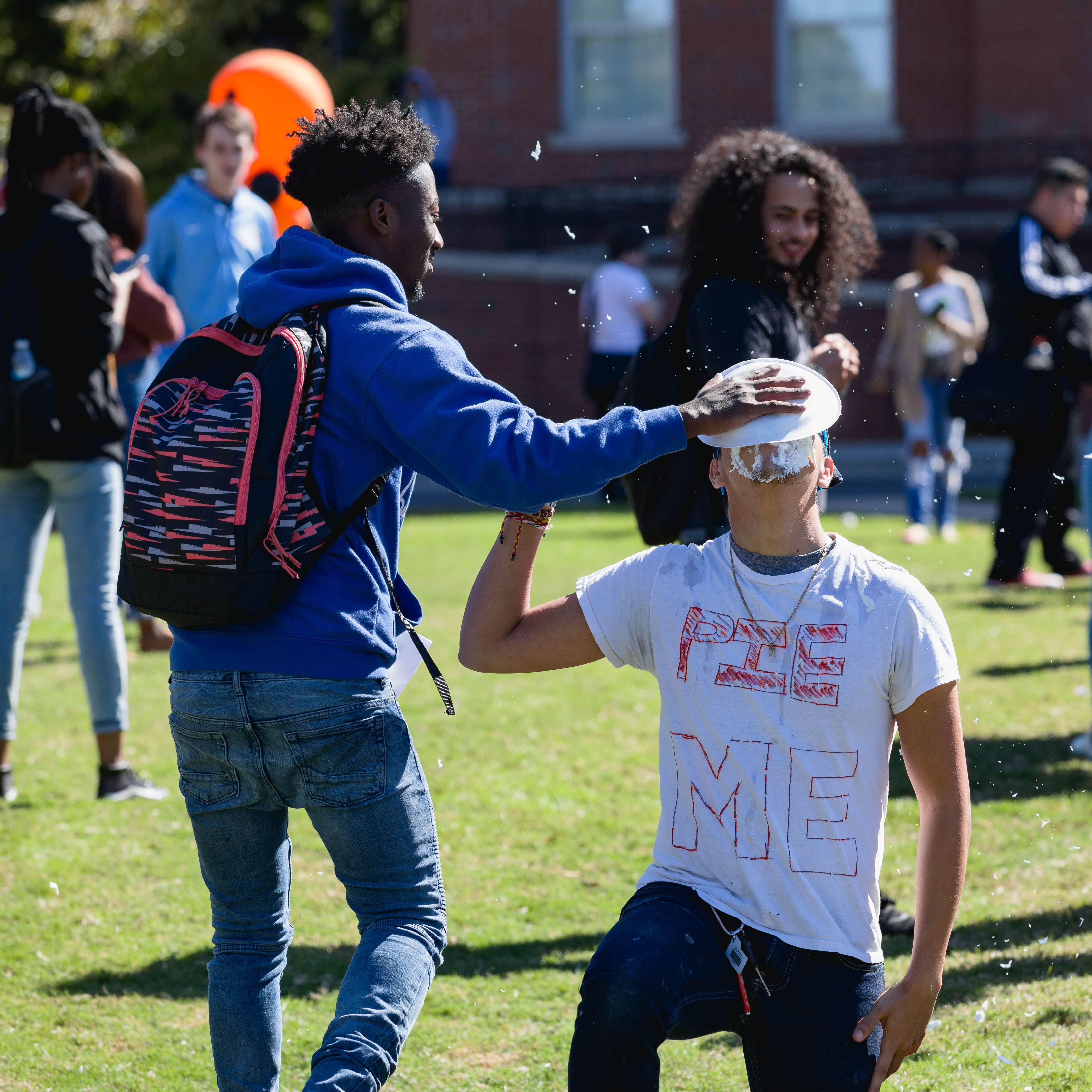 student getting pied in the face at a Central Piedmont event