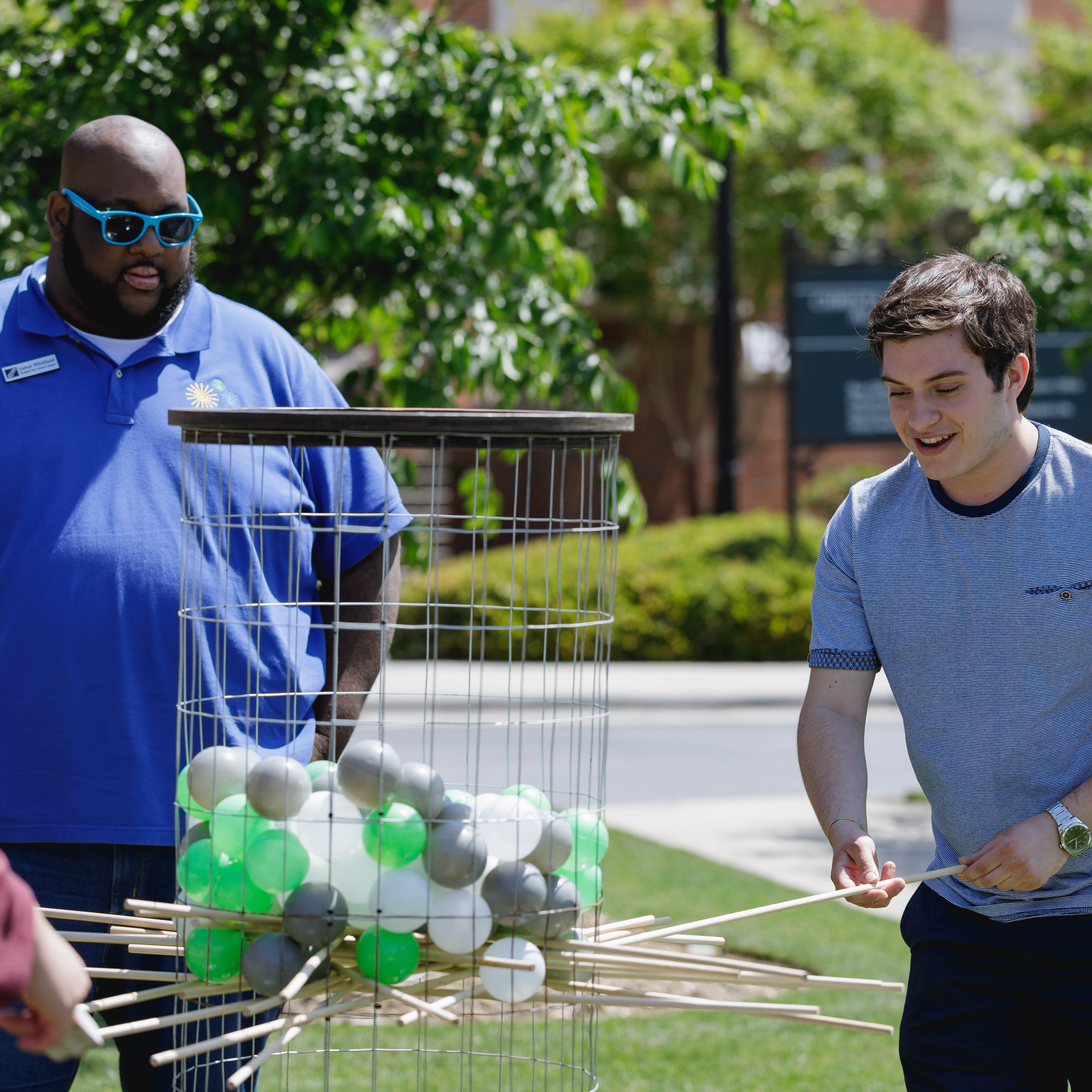 student playing stick and ball game at a student life event