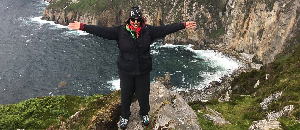 student studying abroad in Ireland by sea cliff