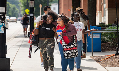 Girls laughing and waling on campus