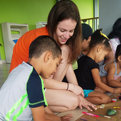 student abroad working with children