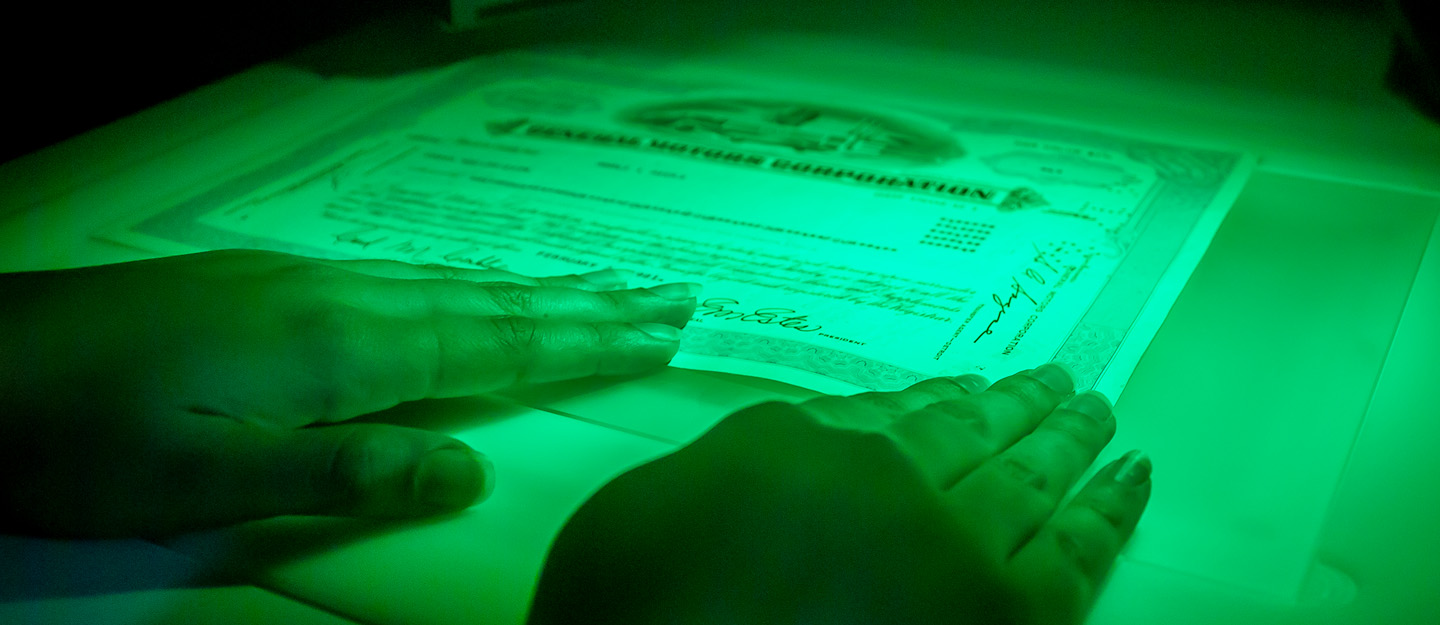 document under special lighting to detect counterfeit