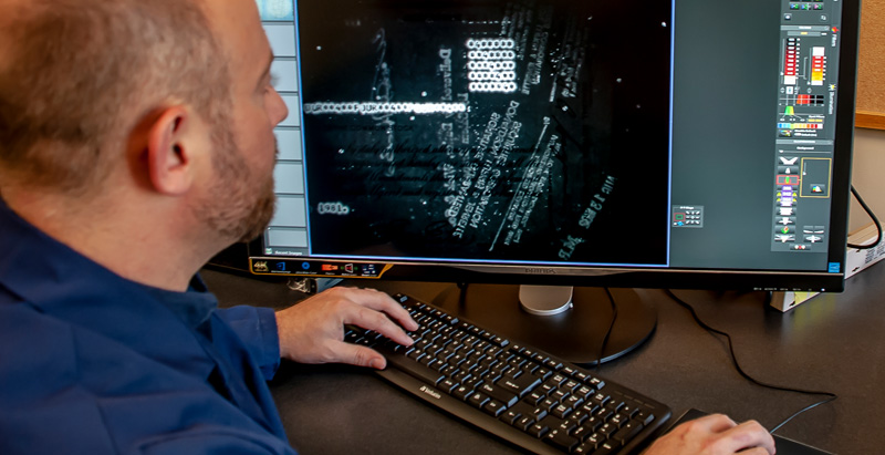 man examining results of document tests on computer