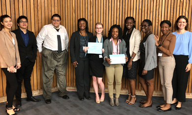 Students standing in group with award