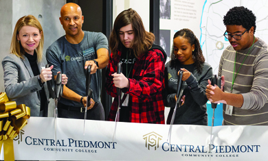 Dr. D and students cut the ribbon at Junior Achievement launch event