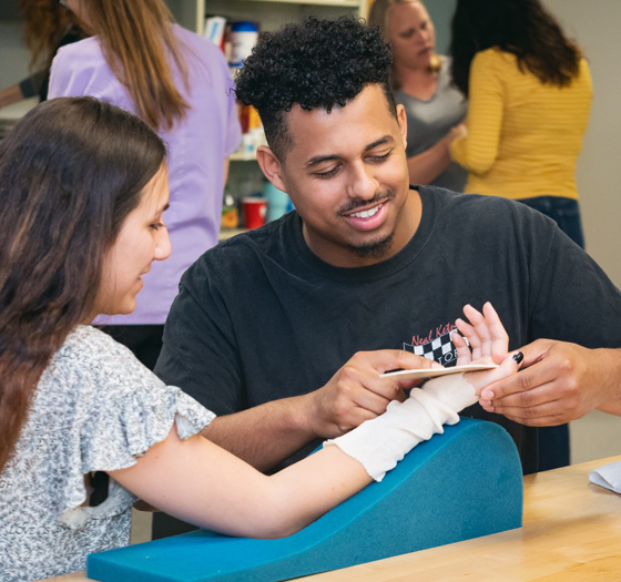 Occupational therapy assistant helping patient