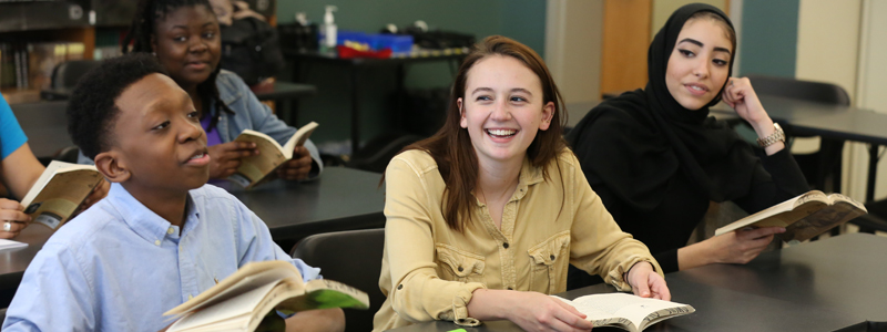 Career and College promise students reading books in class