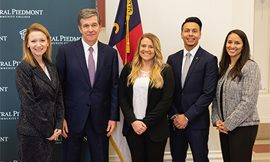 Gov Cooper, Dr. D, and students 