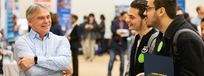 students talking to employer at Career Fair