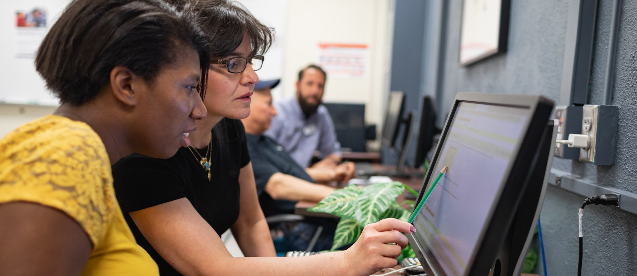 helping student on a computer