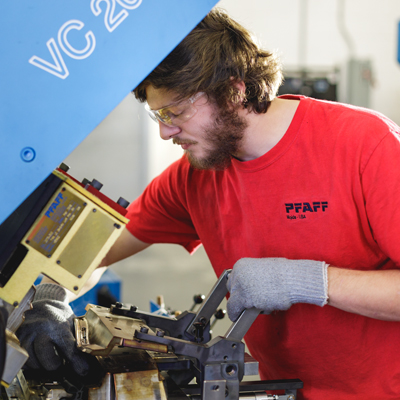 student getting on the job experience using a machine