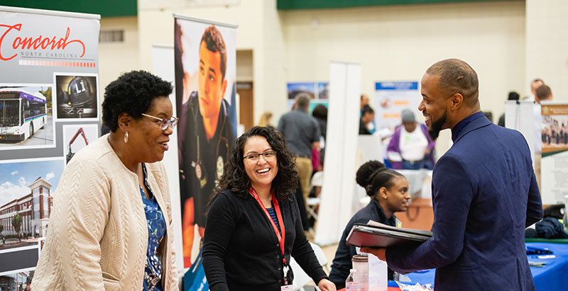 student talking with employers at Central Piedmont Career Fair