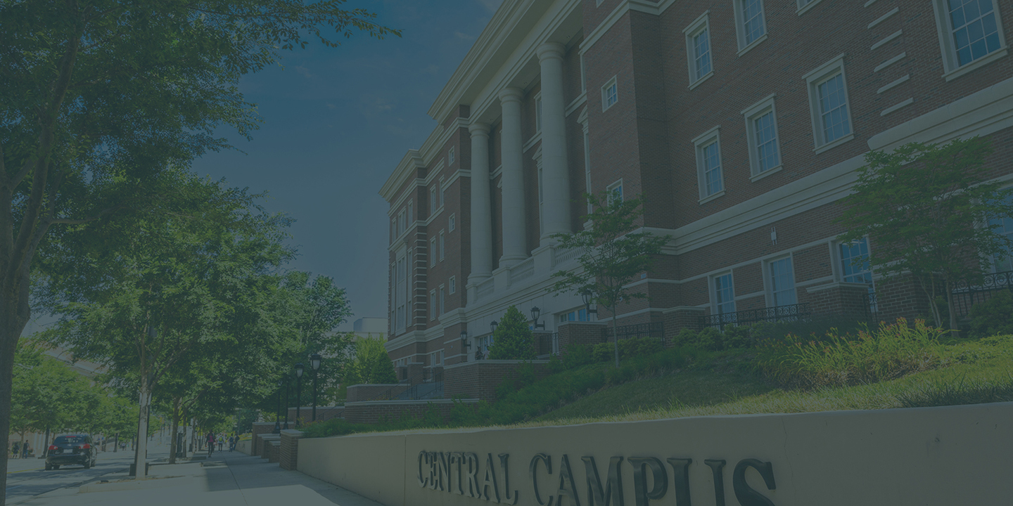 sidewalk in front of Zeiss Building on Central Campus with trees and Central Campus letters on wall