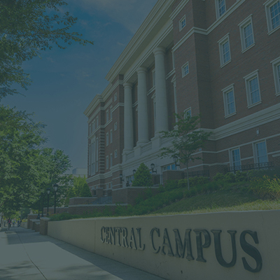 sidewalk in front of Zeiss Building on Central Campus with trees and Central Campus letters on wall