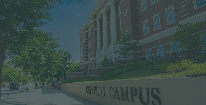 sidewalk in front of Zeiss Building on Central Campus with trees and Central Campus letters on wall