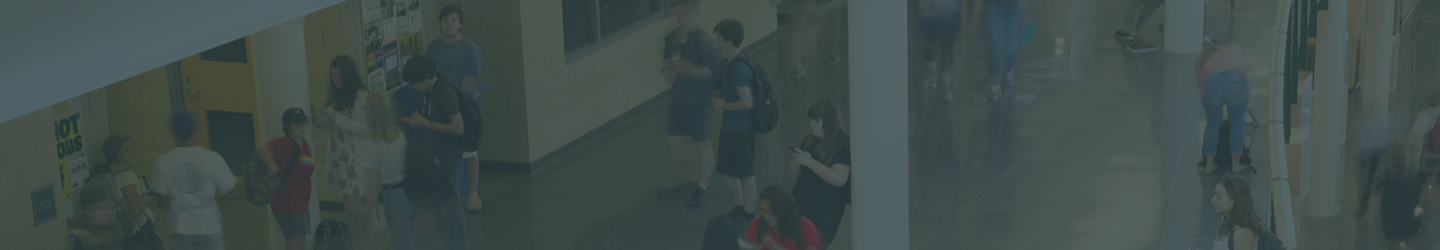 students walking and interacting inside a building atrium