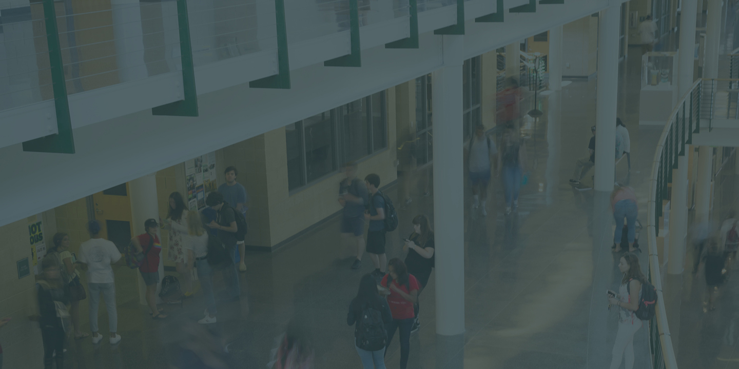 students walking and interacting inside a building atrium