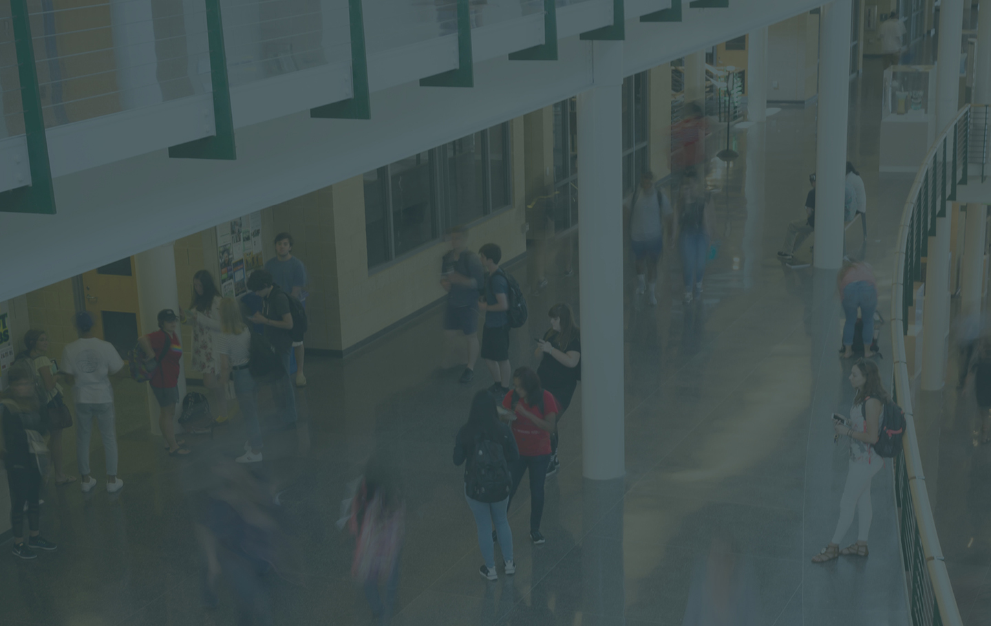 students walking and interacting inside a building atrium