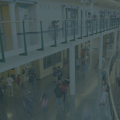 students walking and interacting inside a building atrium