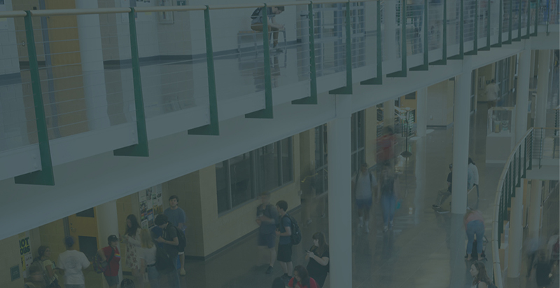 students walking and interacting inside a building atrium