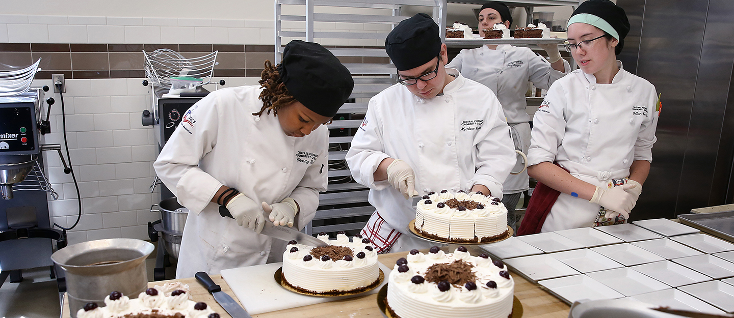 Baking and Pastry Arts program students cutting cakes